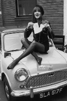 period photo of fashionable woman sitting on mini car