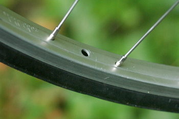 close up of rim and tyre showing empty valve hole